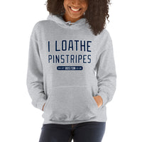photo of a woman wearing a grey hoodie with the words I Loathe Pinstripes on it