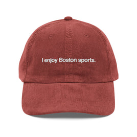 red vintage corduroy baseball cap with the phrase I enjoy Boston sports embroidered in white