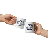 2 people holding 11 oz white ceramic mug with the words i loathe pinstripes in new york yankees lettering navy blue text and boston red sox world series wins