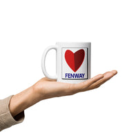 person holding white ceramic mug with the boston fenway citgo sign in the shape of a heart