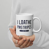 person holding 11 oz white ceramic mug with the words i loathe pinstripes in new york yankees lettering navy blue text and boston red sox world series wins