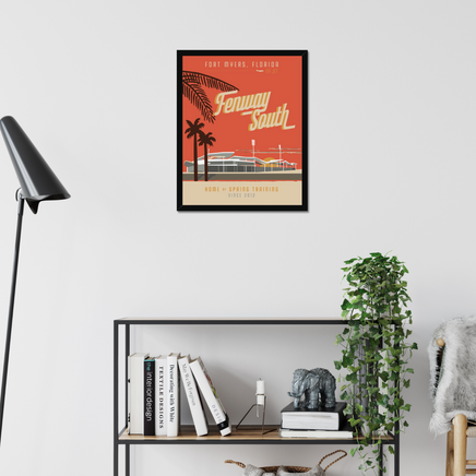 16x20 Fenway South art print with red background and jetblue park with palm trees. In a black frame Mounted on a grey wall in a living room